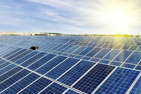 Solar panels gleaming under the bright sun, harnessing renewable energy on a clear, sunny day.