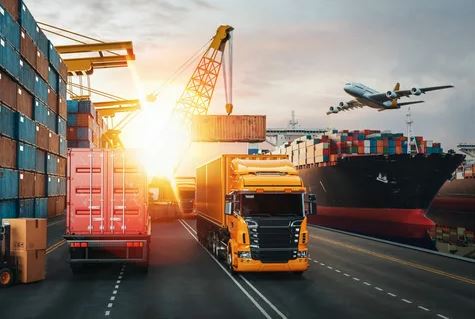 Trucks and cargo containers on a road with an airplane flying in the background, showcasing transportation and logistics.