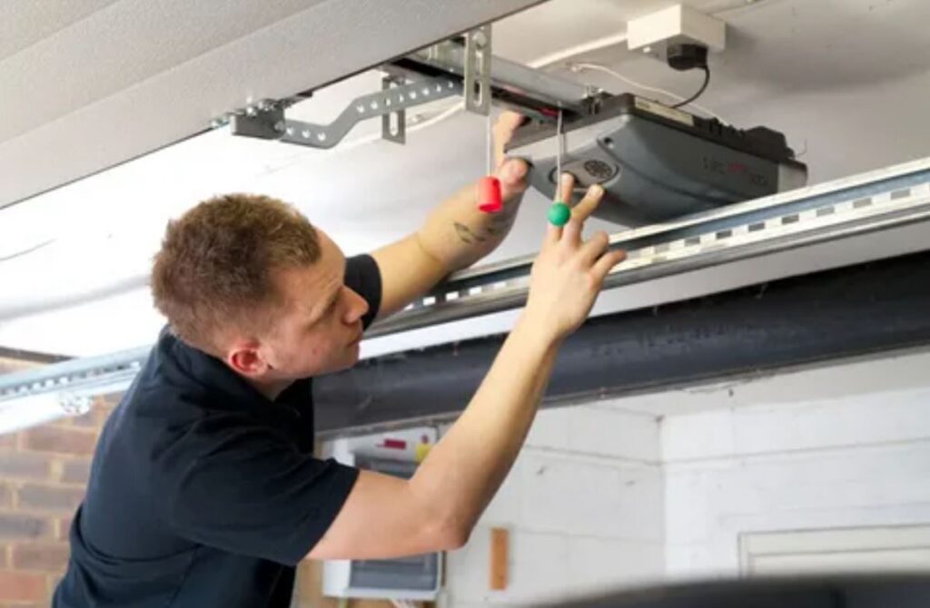 Garage door repair service in London, showcasing a technician fixing a garage door with tools and equipment.